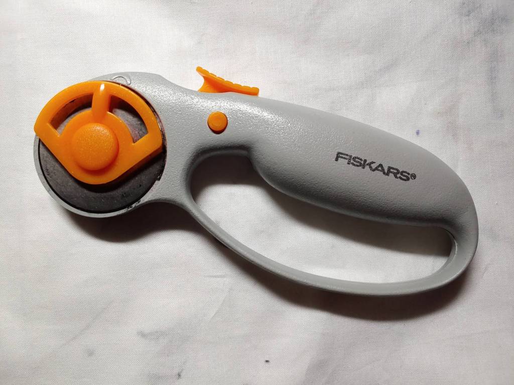 A rotary cutter. I call it the pizza cutter because of its shape.