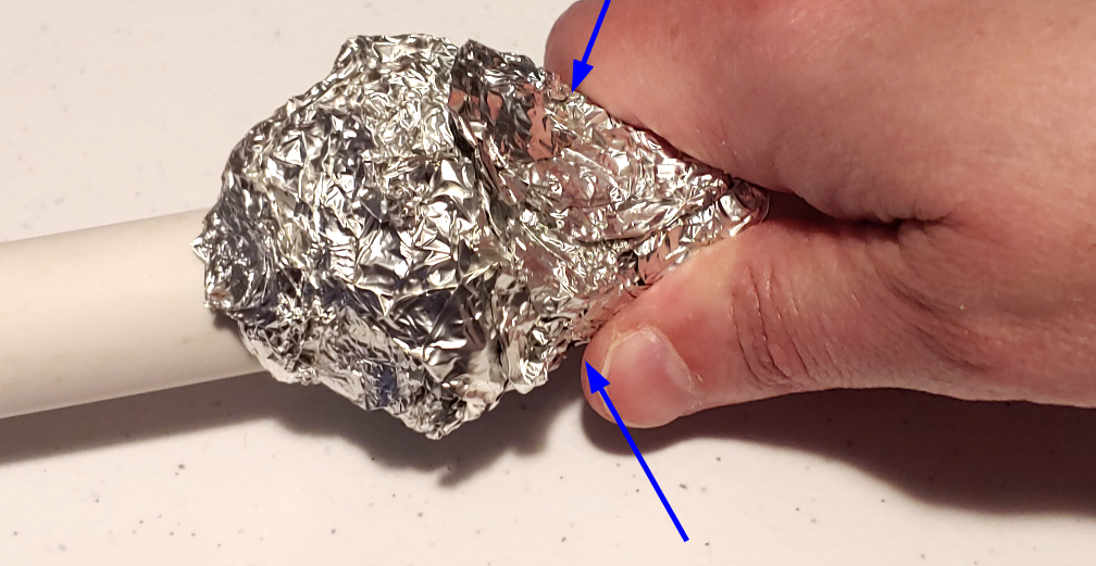Squeeze the foil around the stick base to make a cone-like shape that resembles a knot.