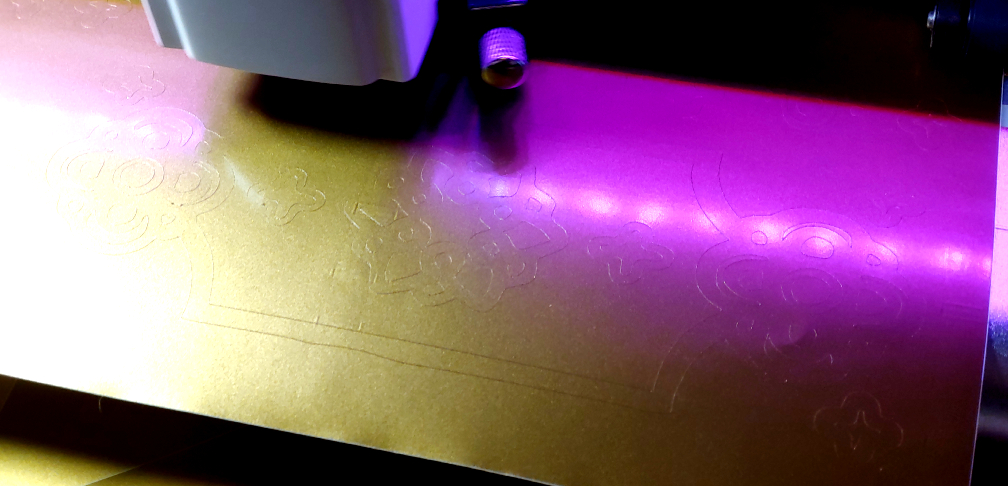 Cutting out complex designs. The purple lights are from my cutter.